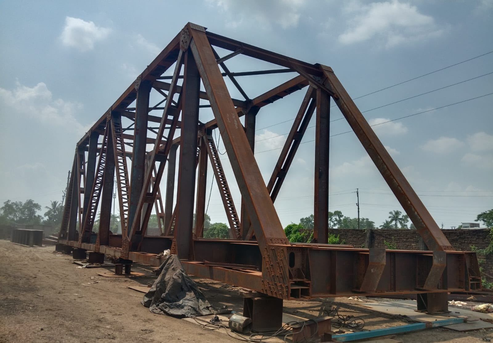 Unpainted steel through-truss girder, fully assembled in the Metal Craft yard, Kolkata